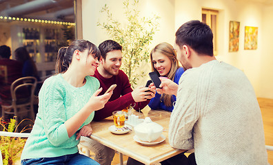 Image showing group of friends with smartphones meeting at cafe