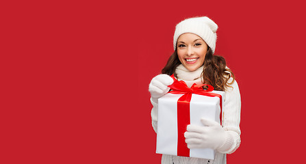 Image showing smiling woman in white clothes with gift box