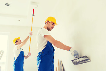 Image showing group of builders with tools indoors