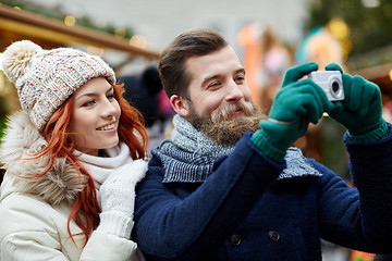 Image showing couple taking selfie with smartphone in old town