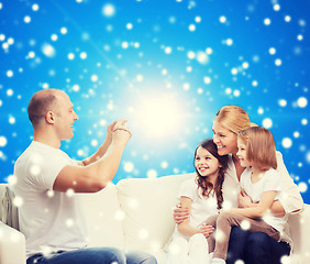 Image showing happy family with camera at home