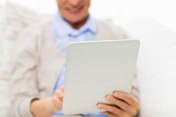 Image showing close up of senior woman with tablet pc at home