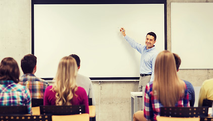 Image showing group of students and smiling teacher in classroom