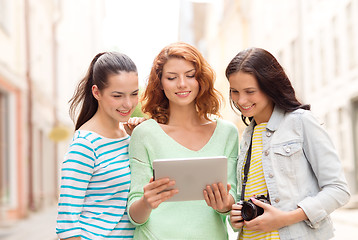 Image showing smiling teenage girls with tablet pc and camera