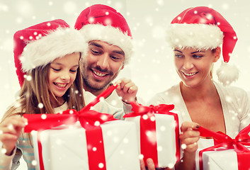 Image showing happy family sitting on couch at home