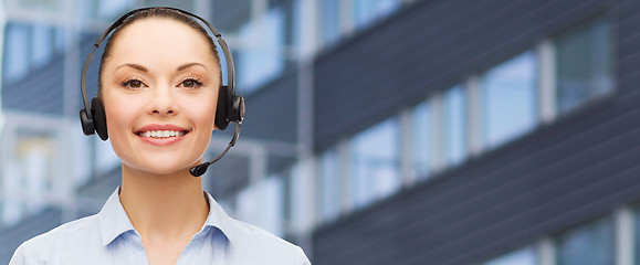 Image showing helpline operator in headset over business center