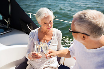 Image showing senior couple clinking glasses on boat or yacht