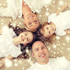 Image showing parents and two girls lying on floor at home