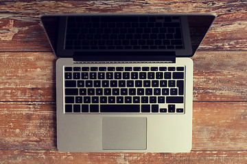 Image showing laptop computer with black blank screen on table