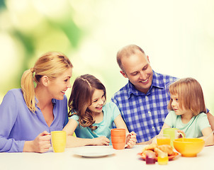 Image showing happy family with two kids with having breakfast