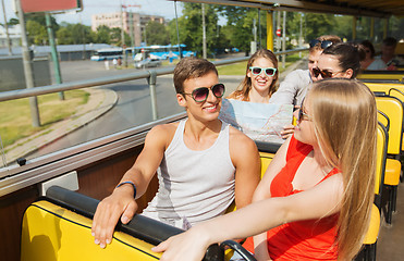 Image showing group of smiling friends traveling by tour bus