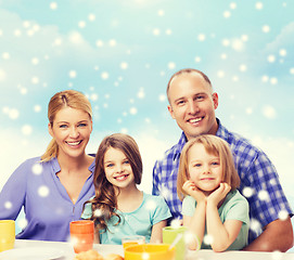 Image showing happy family with two kids having breakfast