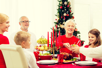 Image showing smiling family having holiday dinner at home