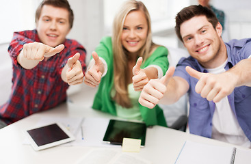 Image showing group of happy students showing thumbs up