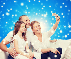 Image showing happy family with camera at home