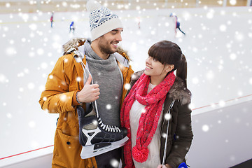 Image showing happy couple with ice-skates on skating rink