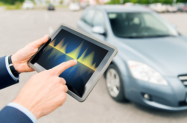 Image showing close up of hands with diagram tablet pc and car