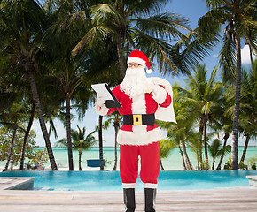 Image showing man in costume of santa claus with notepad and bag