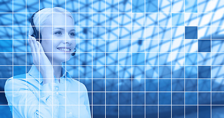 Image showing helpline operator in headset over blue grid