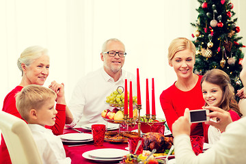 Image showing smiling family having holiday dinner at home