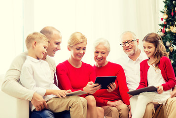 Image showing smiling family with tablet pc computers at home