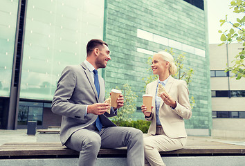 Image showing smiling businessmen with paper cups outdoors