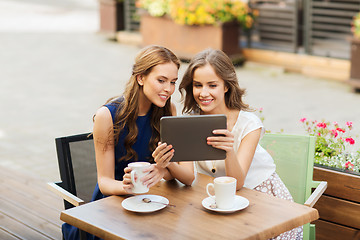 Image showing young women with tablet pc and coffee at cafe