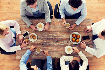 Image showing close up of business team drinking coffee on lunch