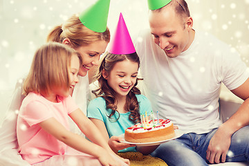 Image showing happy family with two kids in party hats at home