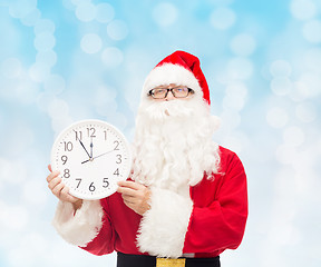 Image showing man in costume of santa claus with clock