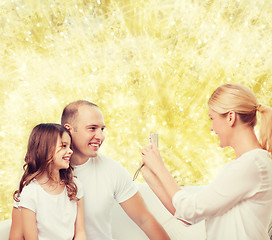 Image showing happy family with camera at home