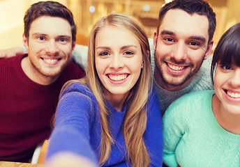 Image showing group of smiling friends taking selfie