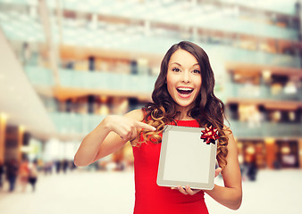 Image showing smiling woman in red dress with tablet pc