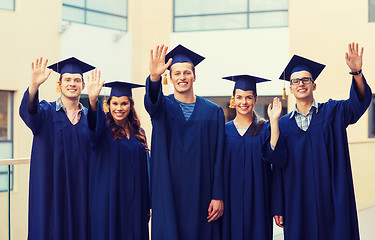 Image showing group of smiling students in mortarboards