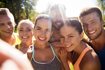 Image showing happy friends taking selfie with smartphone