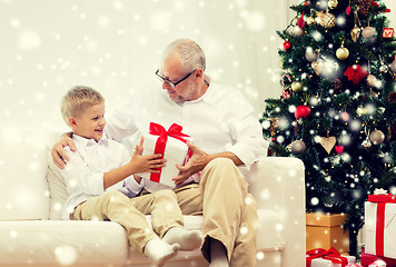 Image showing smiling grandfather and grandson at home