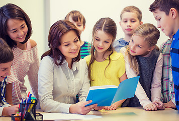 Image showing group of school kids with teacher in classroom