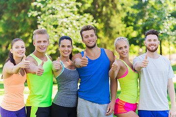 Image showing group of happy sporty friends showing thumbs up