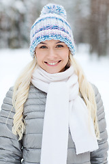 Image showing smiling young woman in winter forest