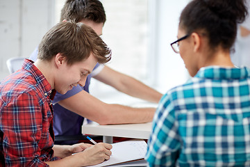 Image showing group of happy high school students with workbook