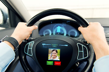Image showing close up of man driving car with incoming call