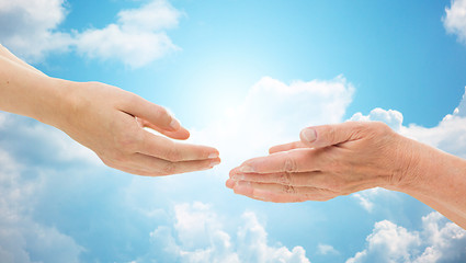 Image showing close up of senior and young woman hands