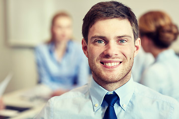 Image showing smiling businessman face in office