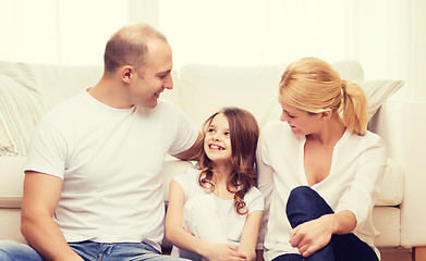 Image showing parents and little girl sitting on floor at home