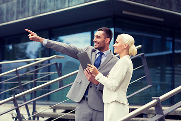 Image showing smiling businessmen with tablet pc outdoors