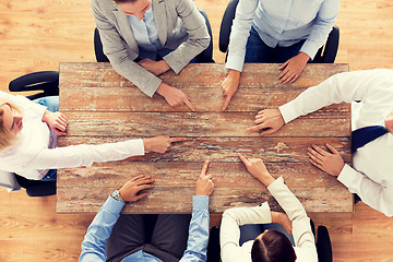 Image showing close up of business team sitting at table