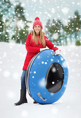Image showing happy teenage girl or woman with snow tube