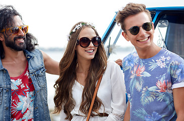 Image showing smiling young hippie friends over minivan car