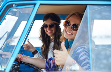 Image showing smiling young hippie women driving minivan car