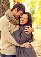 Image showing smiling couple hugging in autumn park